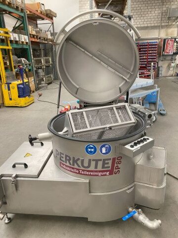 Opened Clean-o-mat SP 80 demonstration system from PERKUTE with visible basket for parts cleaning in industry and workshops